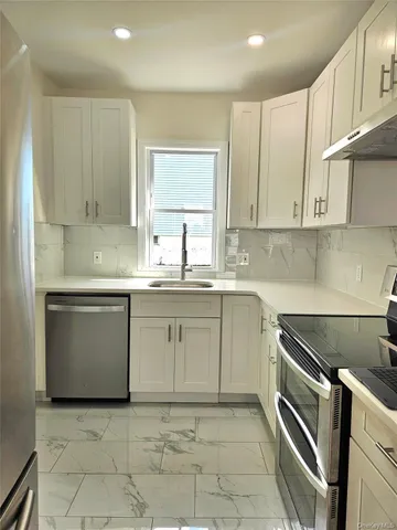 a kitchen with a sink stove and cabinets