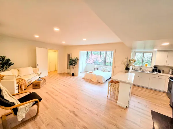 a view of a living room kitchen and a wooden floor