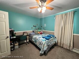 897 Scott Road Dickson City, PA 18519 - Photo 13 of 18 a bedroom with a bed and a chandelier