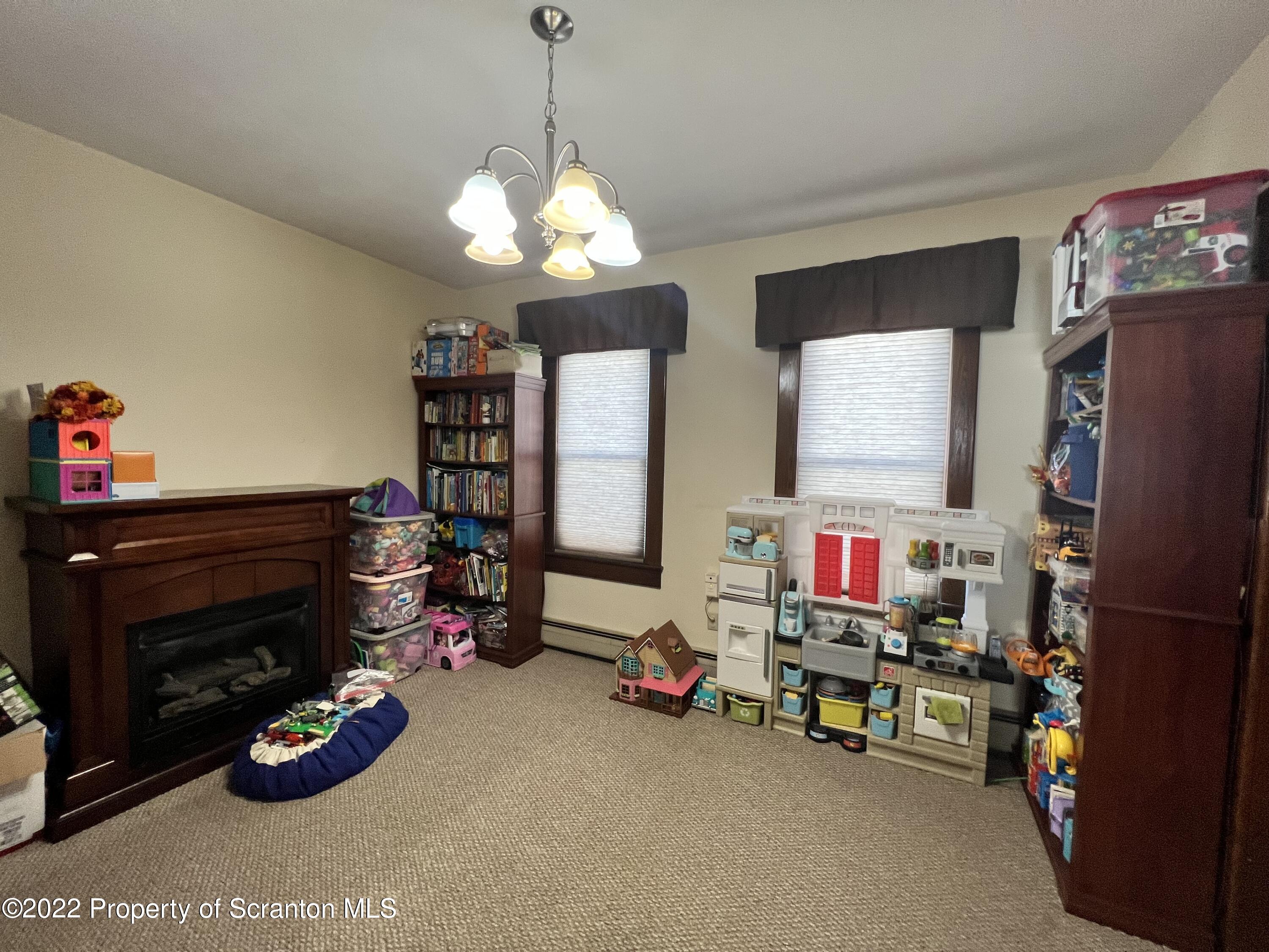 897 Scott Road Dickson City, PA 18519 - Photo 6 of 18 a room with furniture and a chandelier
