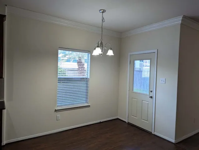 a view of a room with wooden floor and windows