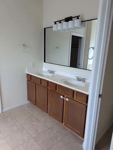 a bathroom with a sink vanity and mirror