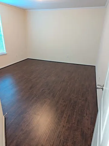an empty room with wooden floor