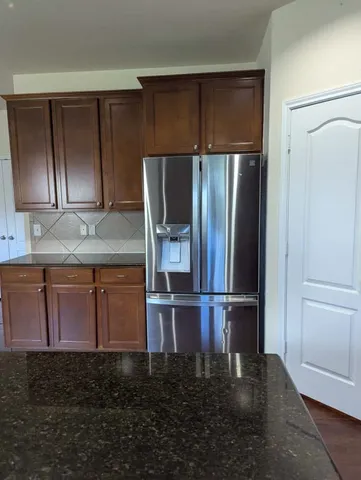 a kitchen with cabinets and stainless steel appliances