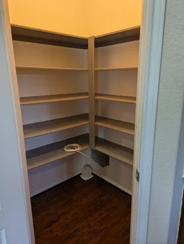 a view of walk in closet with empty racks