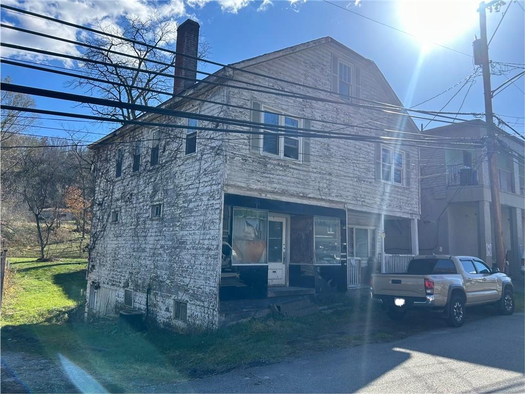 3127 Millers Run Road Cecil, PA 15321 - Photo 2 of 14 a brick building with a bench in front of it