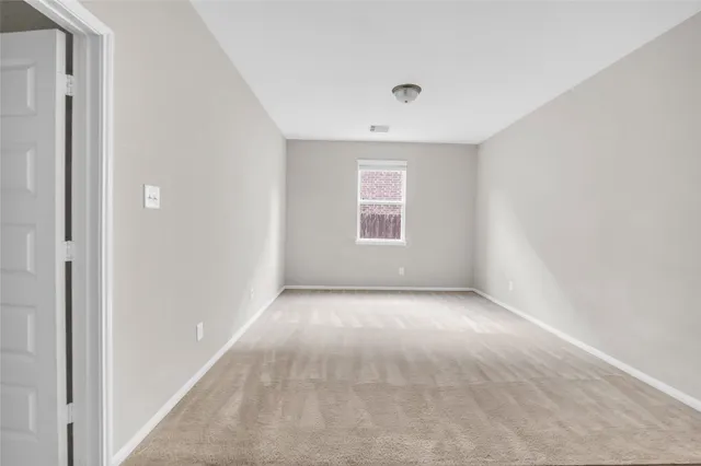 an empty room with a empty space and windows