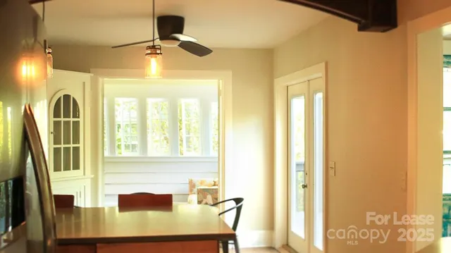 a view of a room with a window and wooden floor