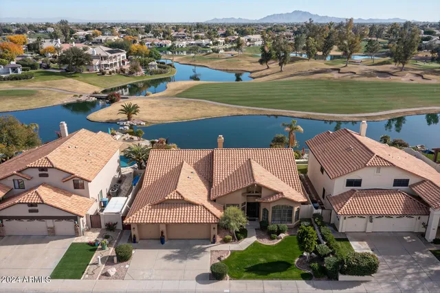 an aerial view of a house with a lake view