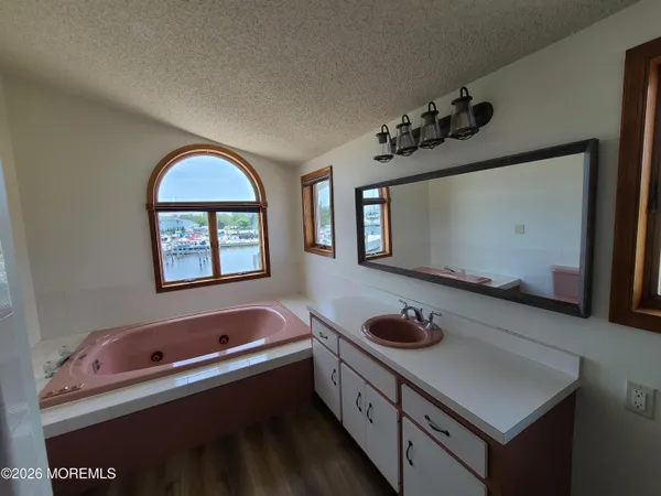a bathroom with a sink a toilet and a mirror