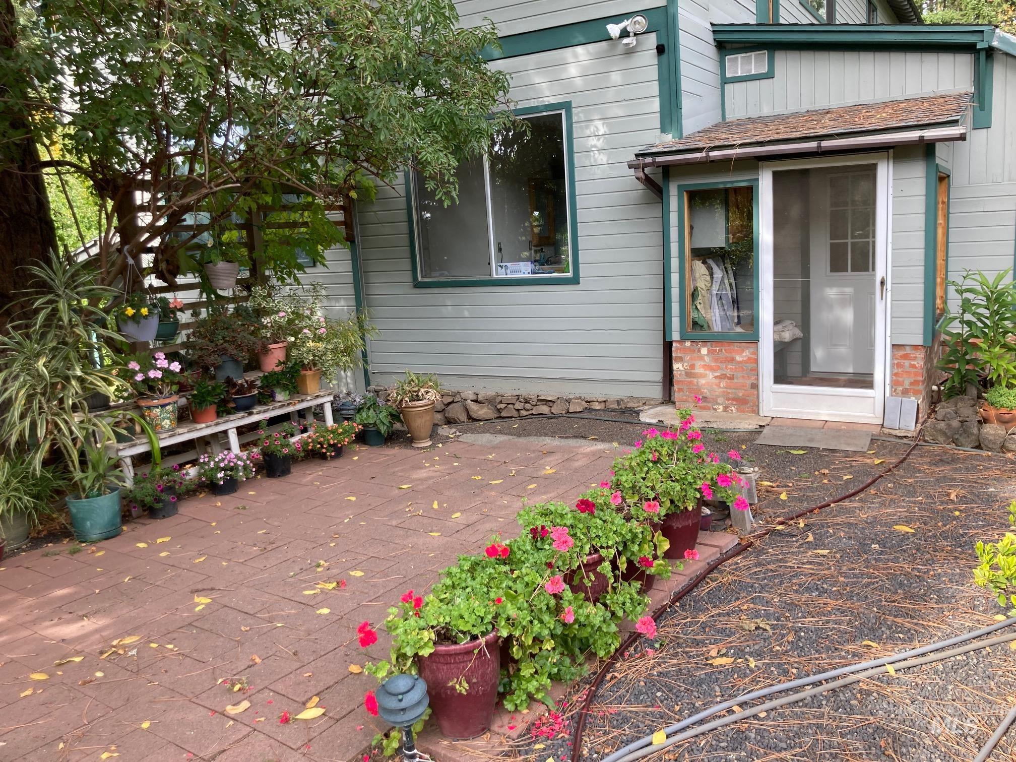 266 Falcon Ridge Road Kooskia, ID 83539 - Photo 35 of 50 Patio area featuring red brick pavers and a screened porch entrance with mud room