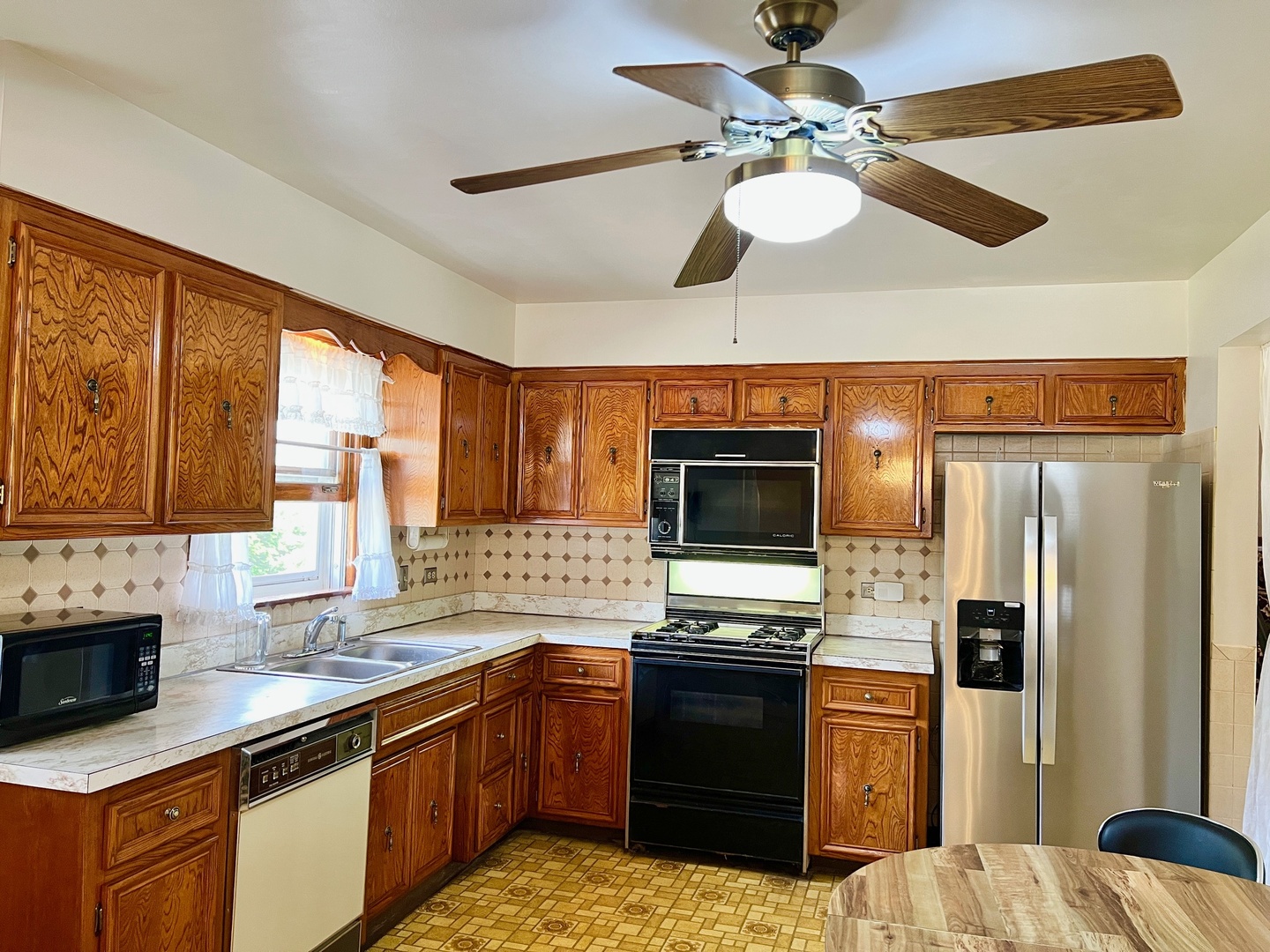 837 North Dee Road Park Ridge, IL 60068 - Photo 8 of 29 a kitchen with stainless steel appliances kitchen island granite countertop a sink stove and refrigerator