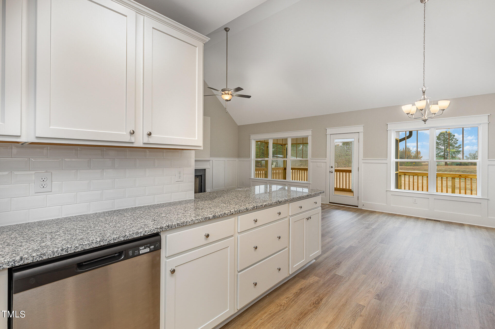 7882 Highway 27 Coats, NC 27521 - Photo 11 of 13 a kitchen with granite countertop white cabinets and a wooden floor