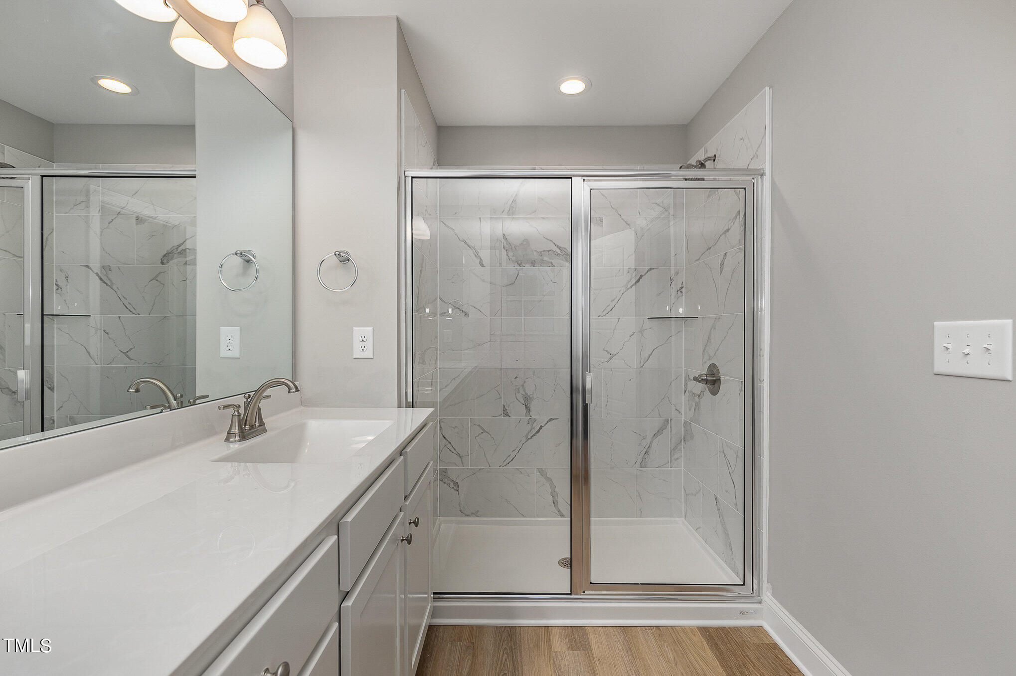 7882 Highway 27 Coats, NC 27521 - Photo 12 of 13 a bathroom with a shower sink vanity and mirror