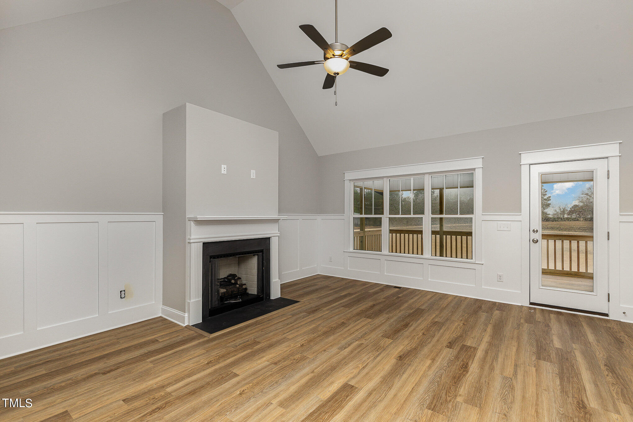 7882 Highway 27 Coats, NC 27521 - Photo 7 of 13 a view of an empty room with a fireplace and a window