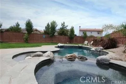 a view of swimming pool with outdoor seating and plants