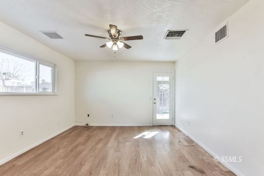 712 South Alvord Street Ridgecrest, CA 93555 - Photo 12 of 33 a view of empty room with wooden floor and fan