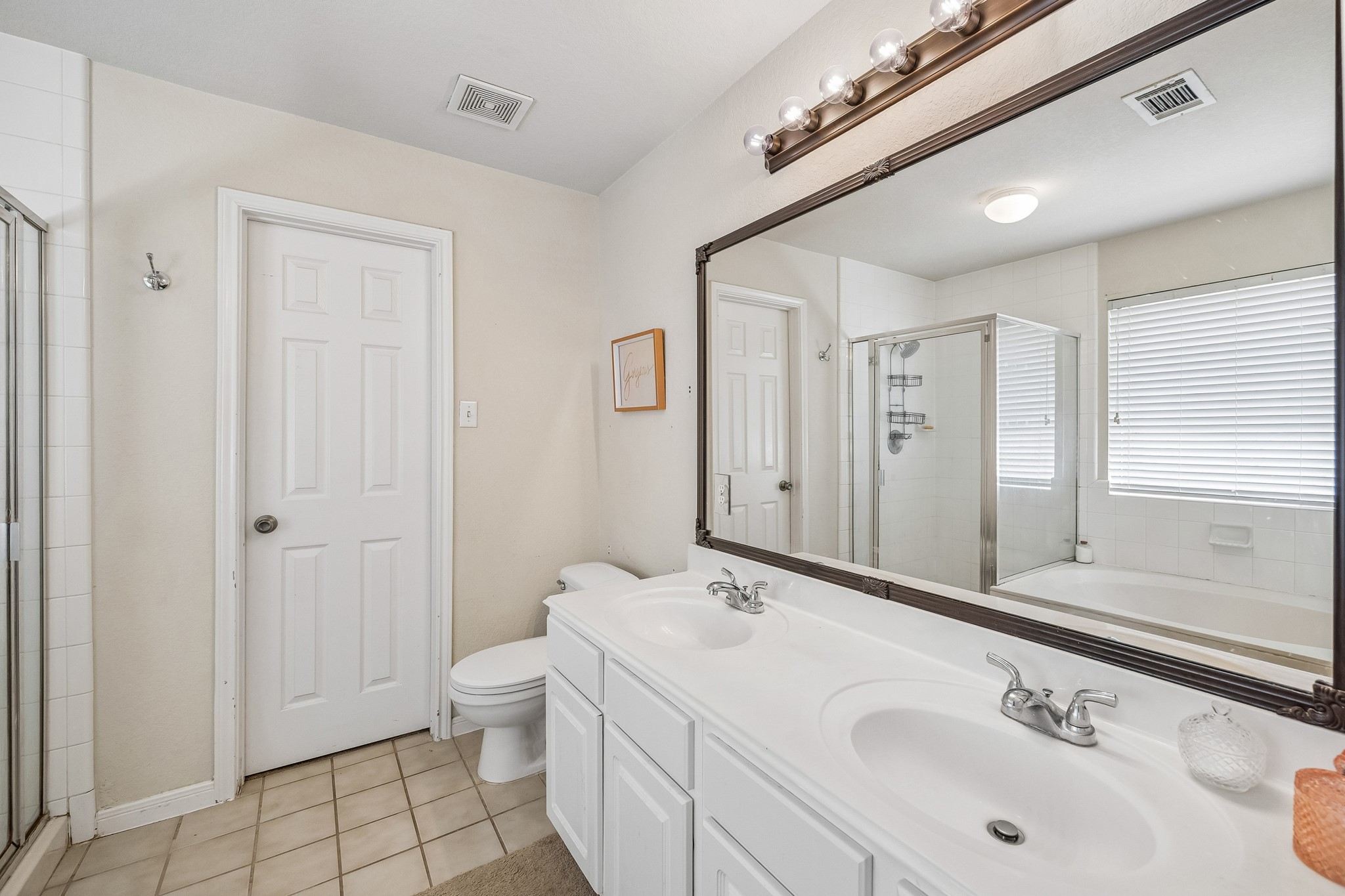 24027 Floragate Drive Spring, TX 77373 - Photo 16 of 21 a bathroom with a sink a toilet and shower