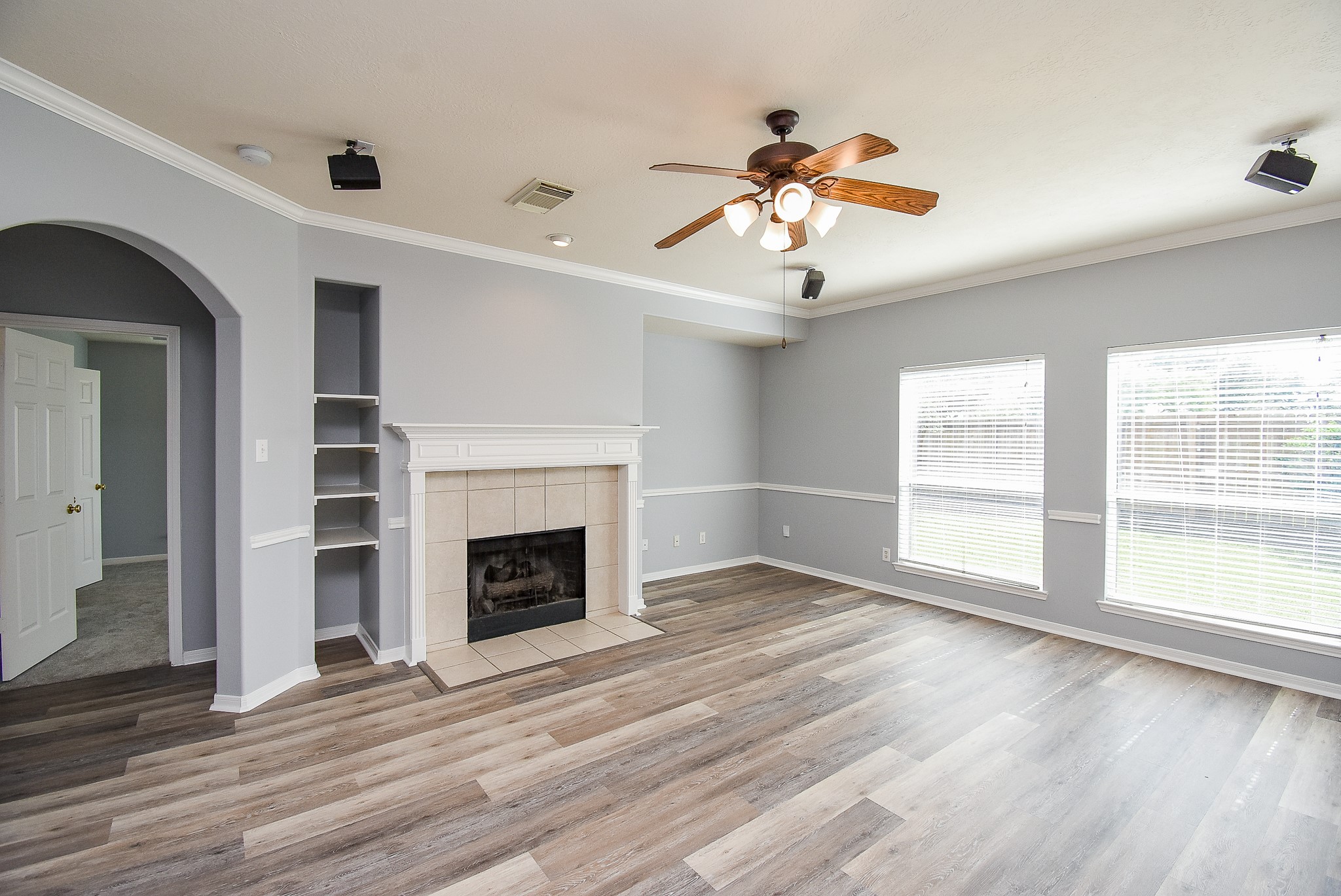 3918 Austin Lake Court Pearland, TX 77581 - Photo 13 of 32 a view of an empty room with wooden floor fireplace and a window
