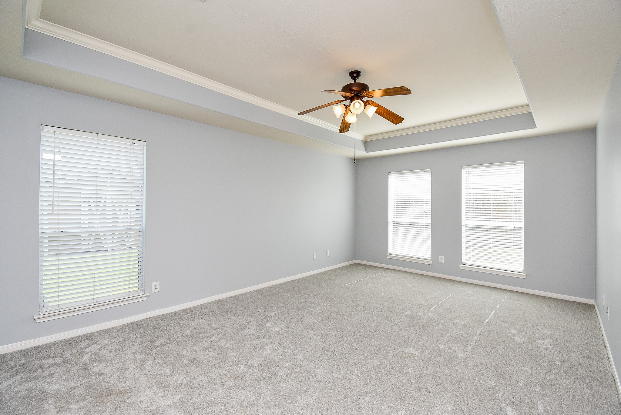 3918 Austin Lake Court Pearland, TX 77581 - Photo 15 of 32 an empty room with windows and a chandelier fan