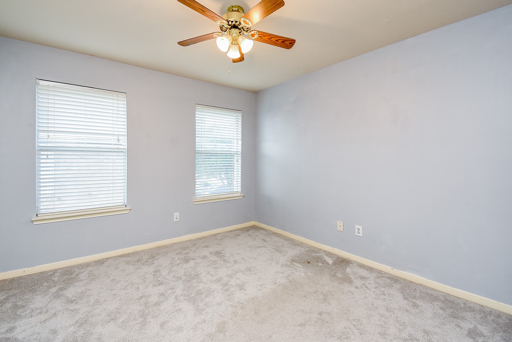 3918 Austin Lake Court Pearland, TX 77581 - Photo 21 of 32 an empty room with windows and fan