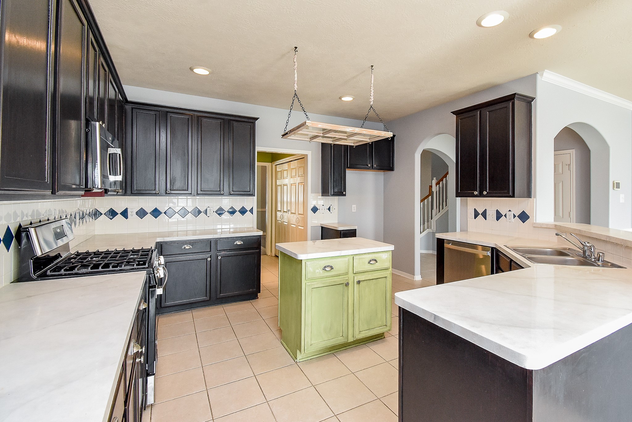 3918 Austin Lake Court Pearland, TX 77581 - Photo 4 of 32 a kitchen filled a sink a counter space and stainless steel appliances