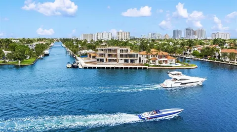 a view of a lake with boats and trees in the background