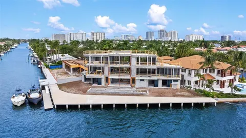 a view of a balcony with a dining table and chairs