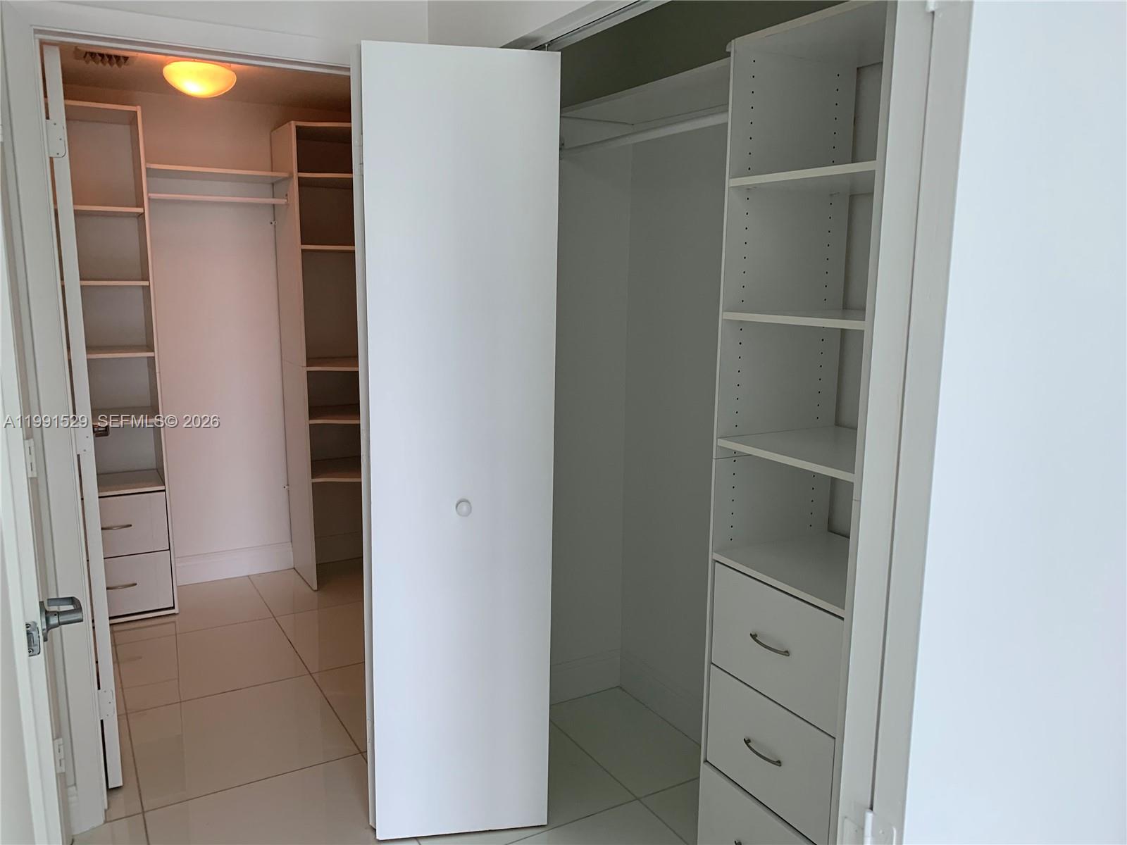 90 Southwest 3rd Street, Unit 3610 Miami, FL 33130 - Photo 13 of 38 a view of walk in closet with empty racks