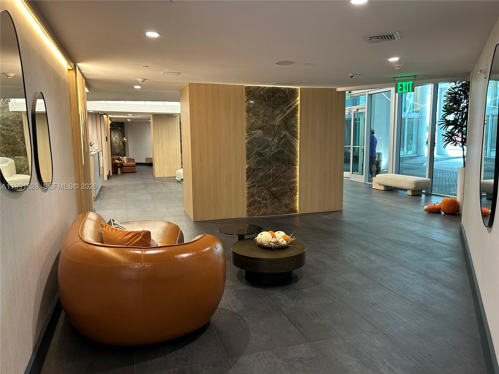 90 Southwest 3rd Street, Unit 3610 Miami, FL 33130 - Photo 19 of 38 a living room with furniture and a wooden floor