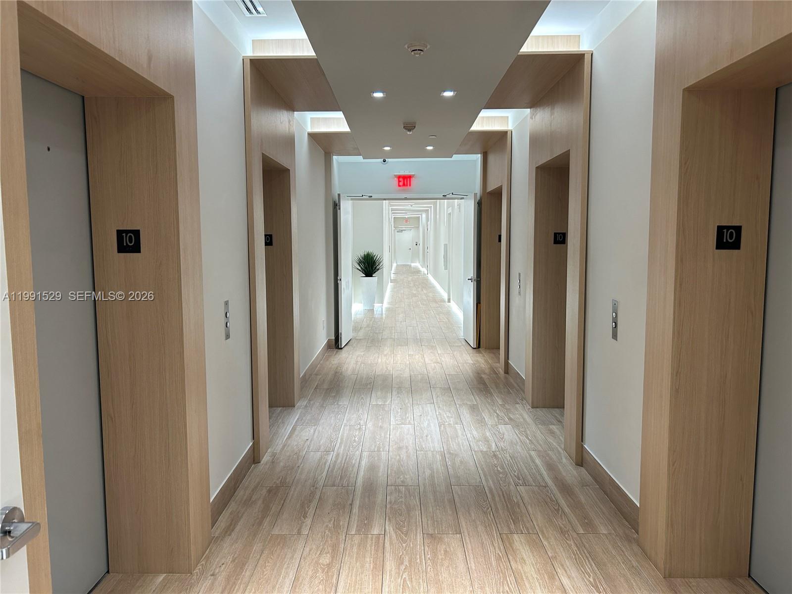 90 Southwest 3rd Street, Unit 3610 Miami, FL 33130 - Photo 21 of 38 a view of a hallway with wooden floor and staircase