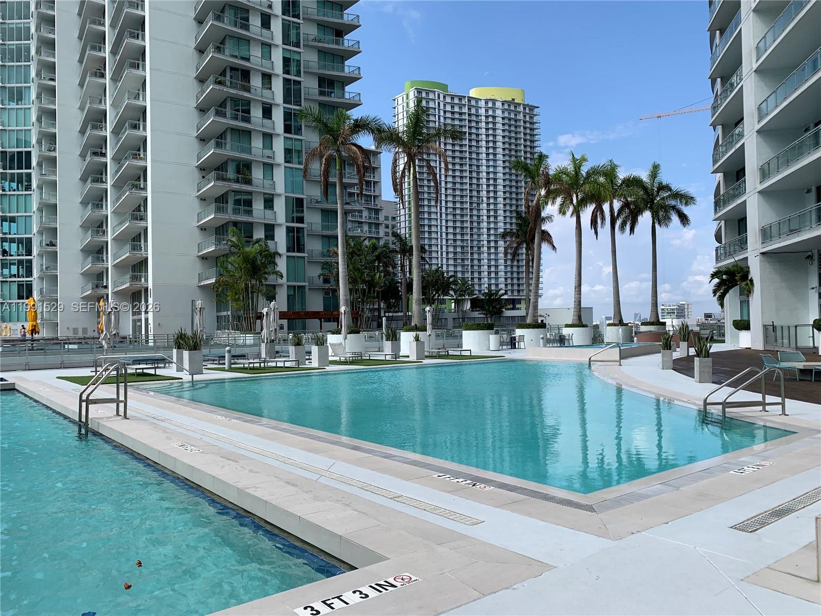 90 Southwest 3rd Street, Unit 3610 Miami, FL 33130 - Photo 23 of 38 a view of swimming pool with outdoor seating and a patio