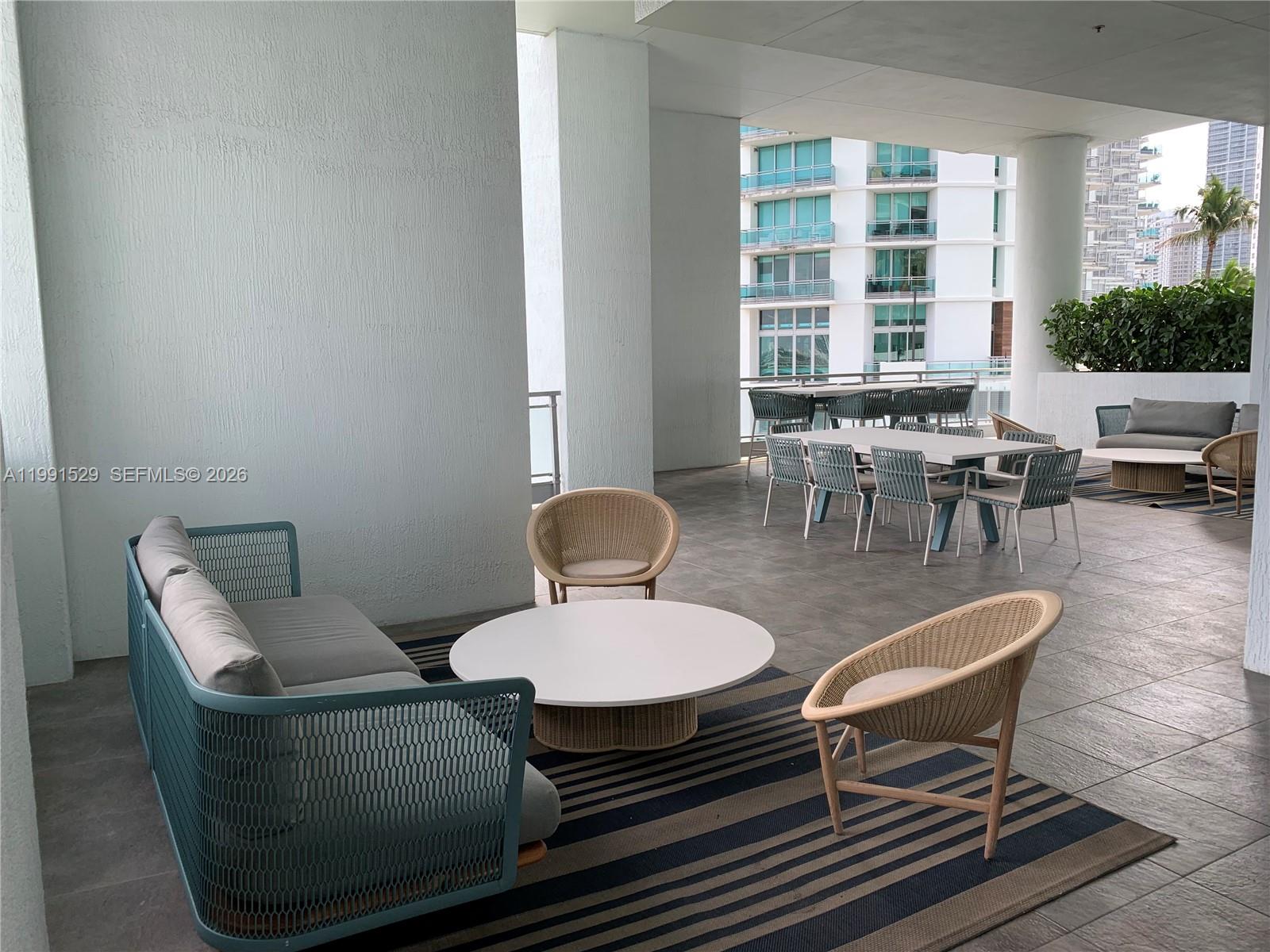 90 Southwest 3rd Street, Unit 3610 Miami, FL 33130 - Photo 26 of 38 a dining room with furniture a window and a table