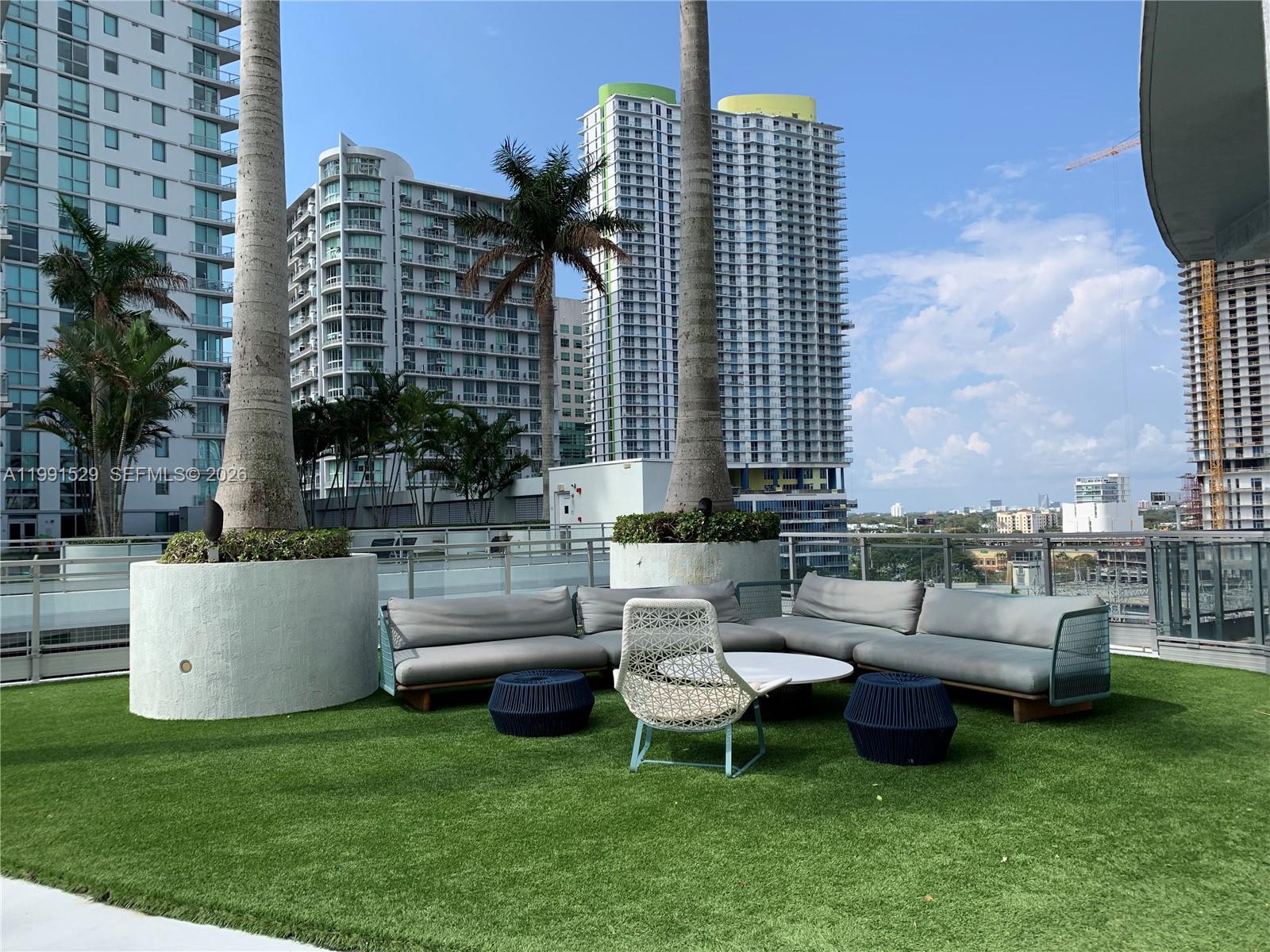 90 Southwest 3rd Street, Unit 3610 Miami, FL 33130 - Photo 28 of 38 a view of a patio with couches and a fire pit