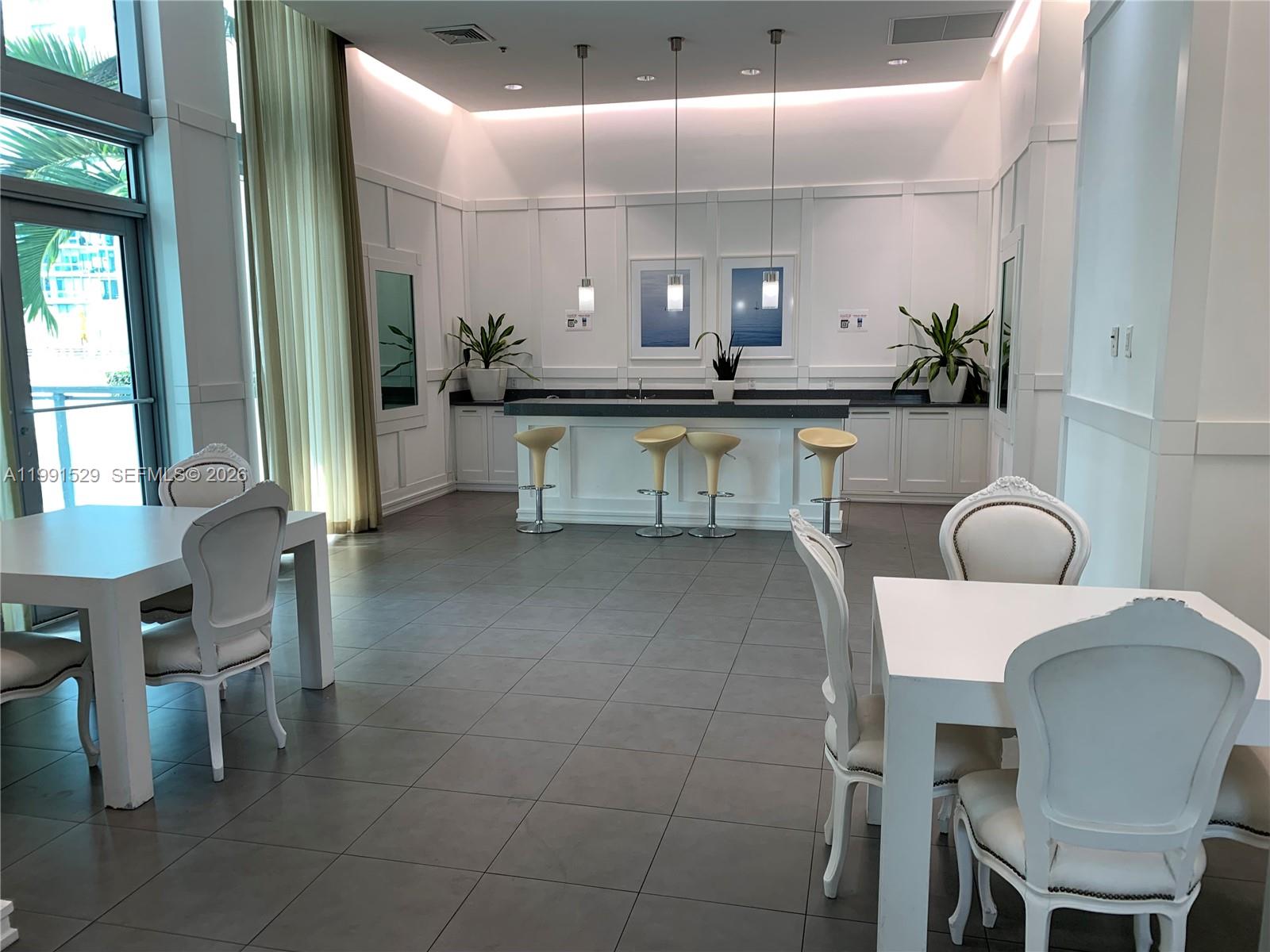 90 Southwest 3rd Street, Unit 3610 Miami, FL 33130 - Photo 34 of 38 a dining room with furniture and a large window
