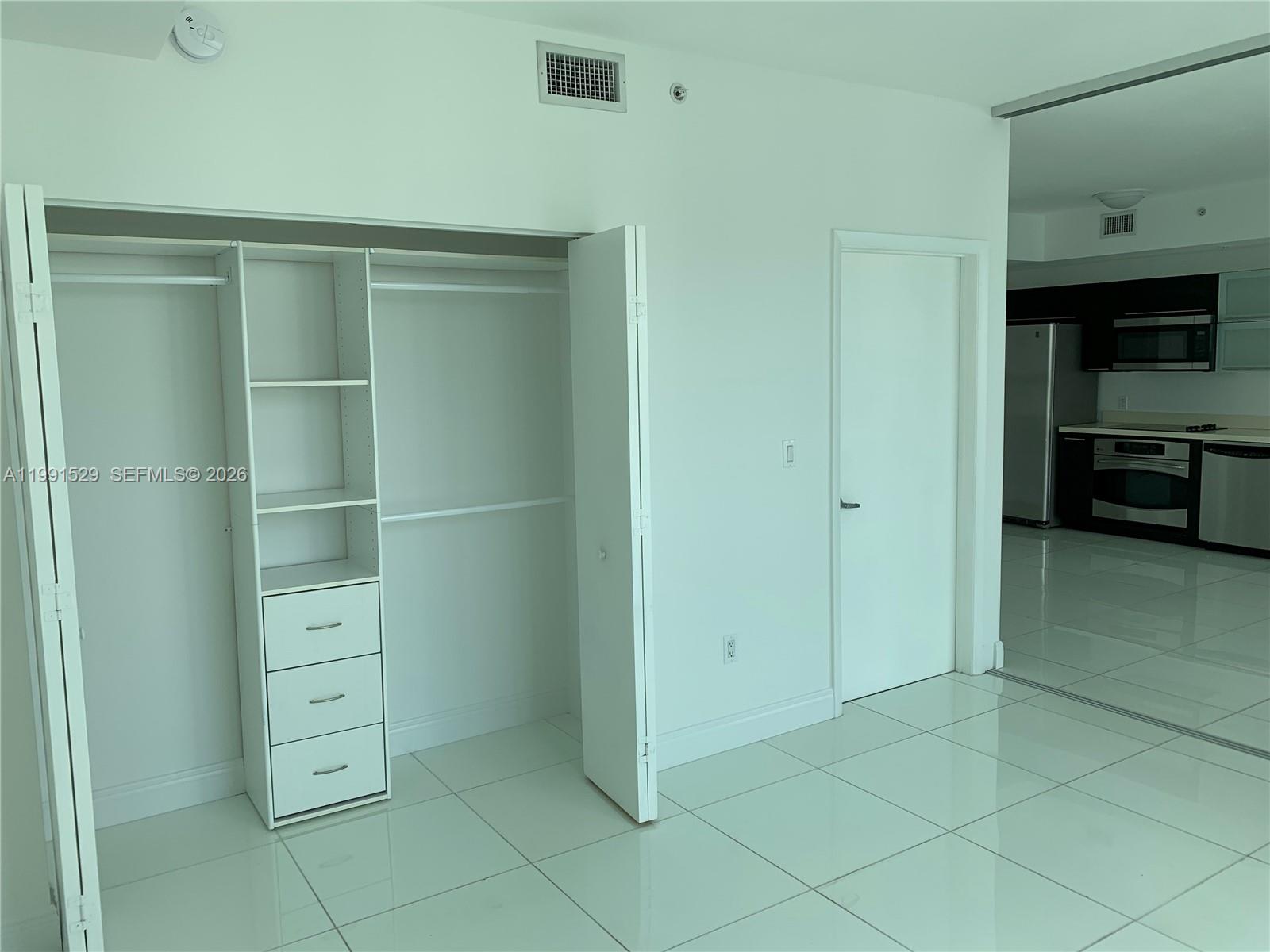 90 Southwest 3rd Street, Unit 3610 Miami, FL 33130 - Photo 10 of 38 a view of walk in closet with empty racks