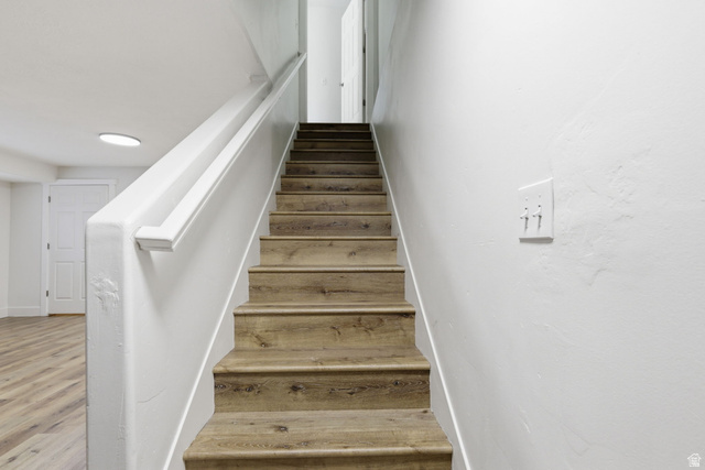 15119 Eagle Chase Drive Draper, UT 84020 - Photo 36 of 66 Staircase featuring wood-finish treads and risers with a white handrail