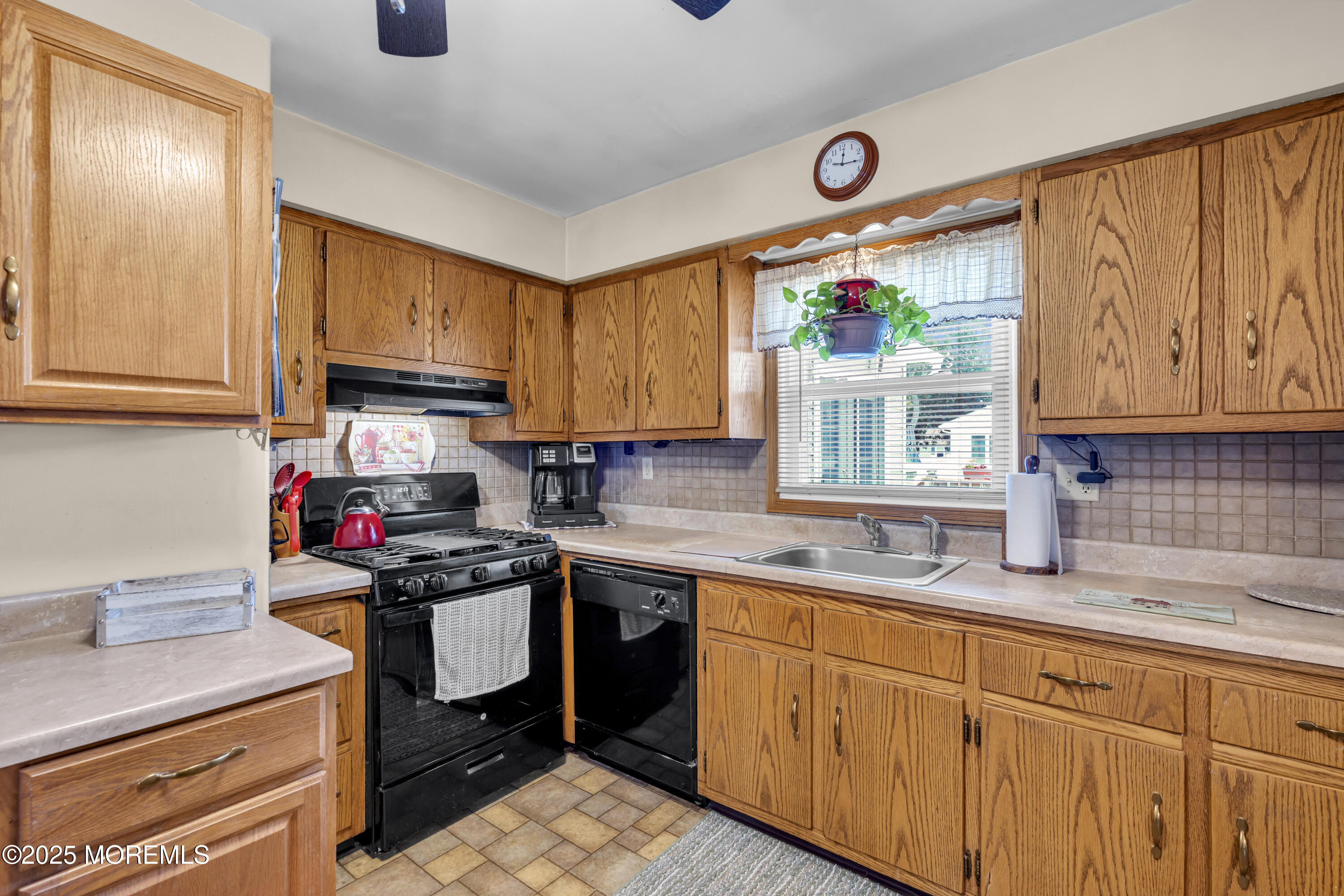 2221 Wilson Road Point Pleasant, NJ 08742 - Photo 16 of 63 a kitchen with stainless steel appliances granite countertop a sink stove and cabinets