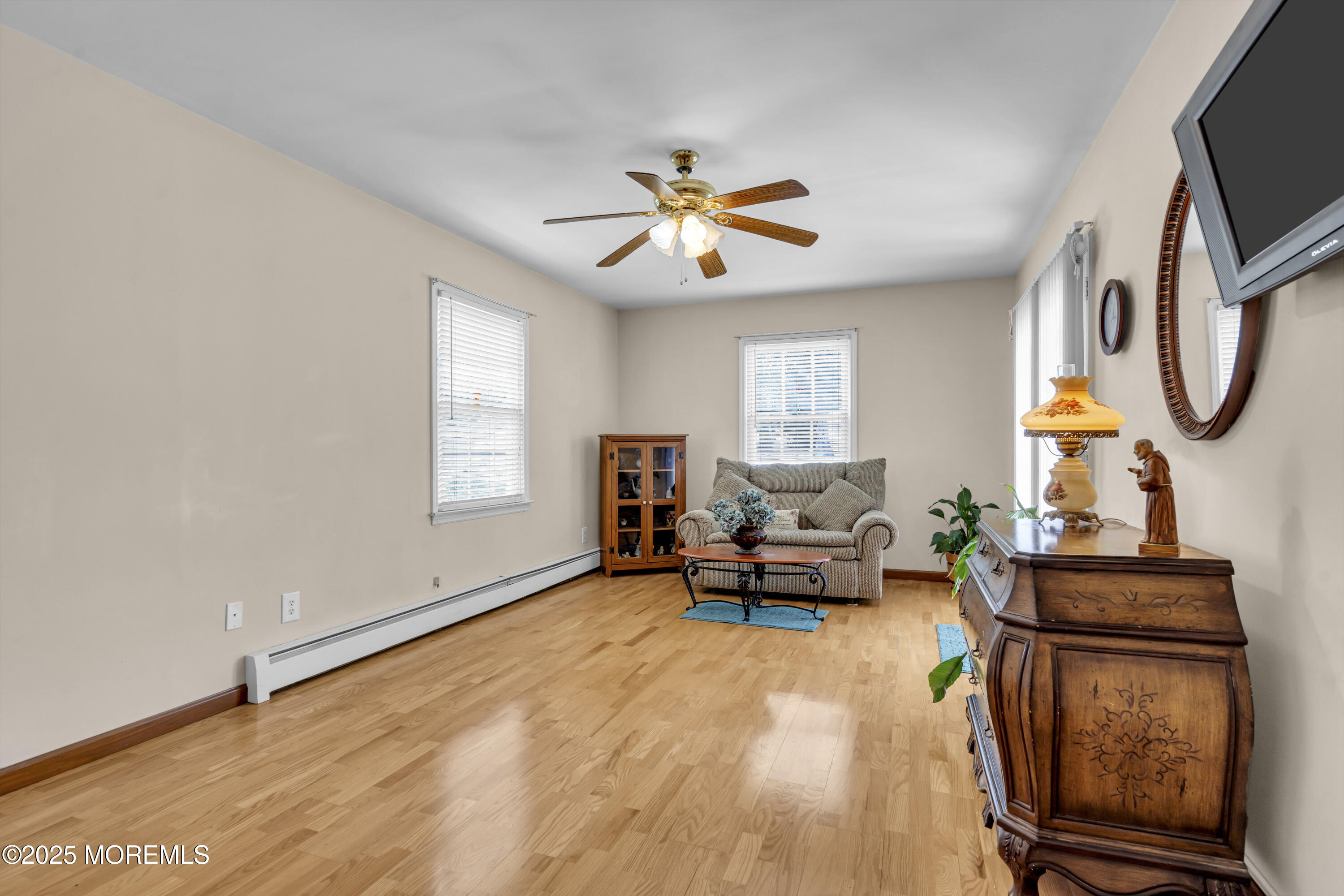 2221 Wilson Road Point Pleasant, NJ 08742 - Photo 27 of 63 a living room with furniture a flat screen tv and a window