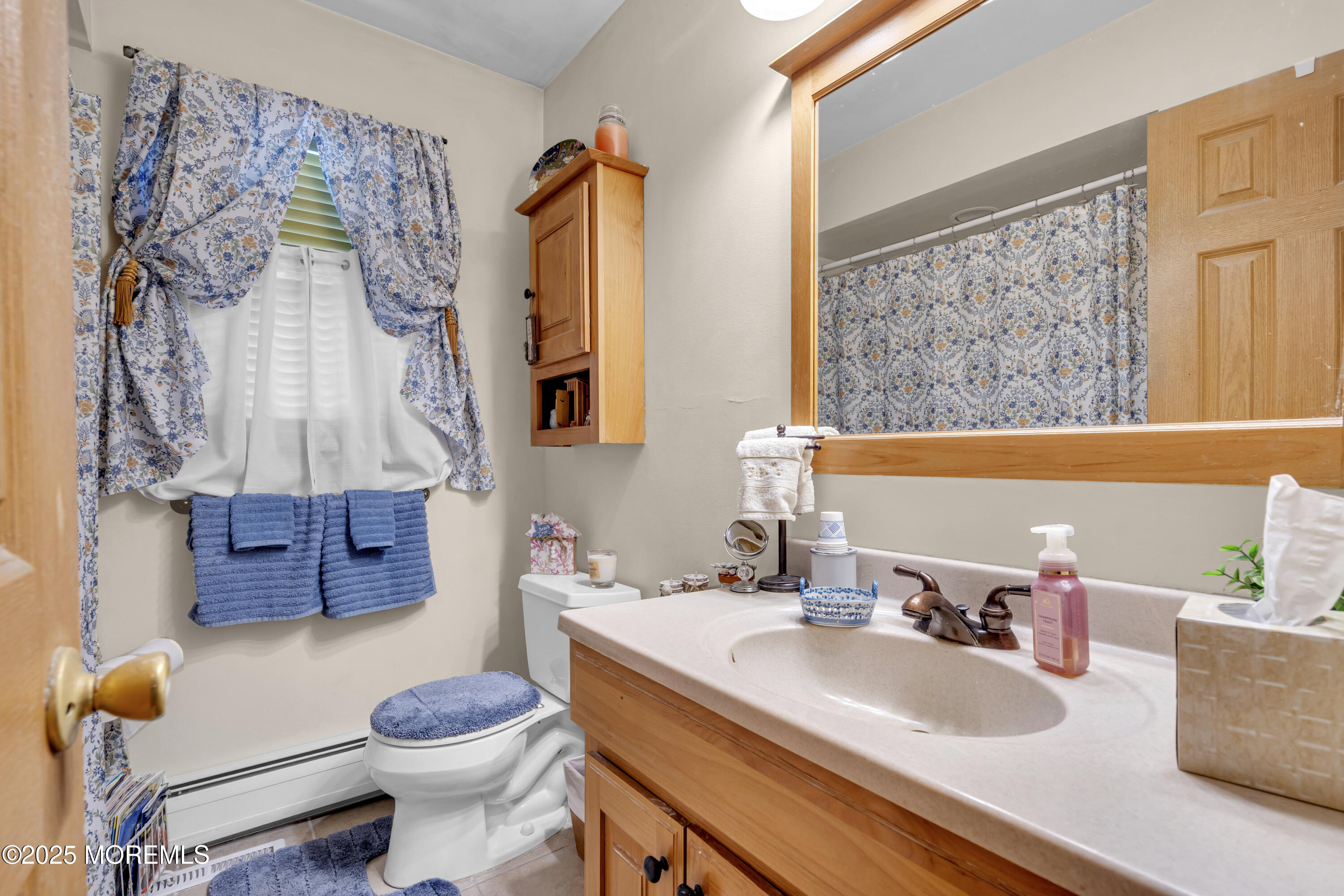 2221 Wilson Road Point Pleasant, NJ 08742 - Photo 34 of 63 a bathroom with a granite countertop sink and a mirror