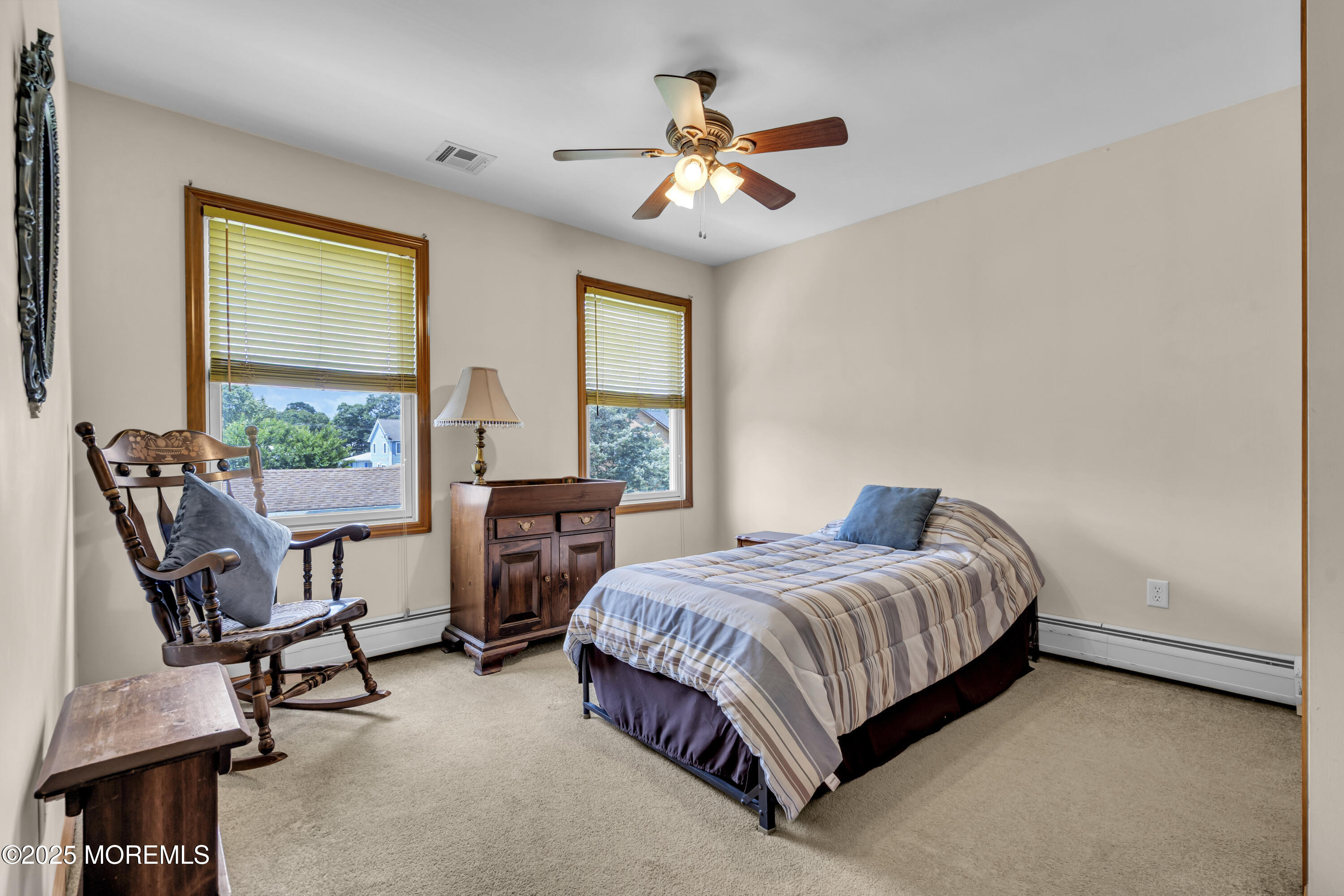 2221 Wilson Road Point Pleasant, NJ 08742 - Photo 42 of 63 a bedroom with a bed a chair and a large window