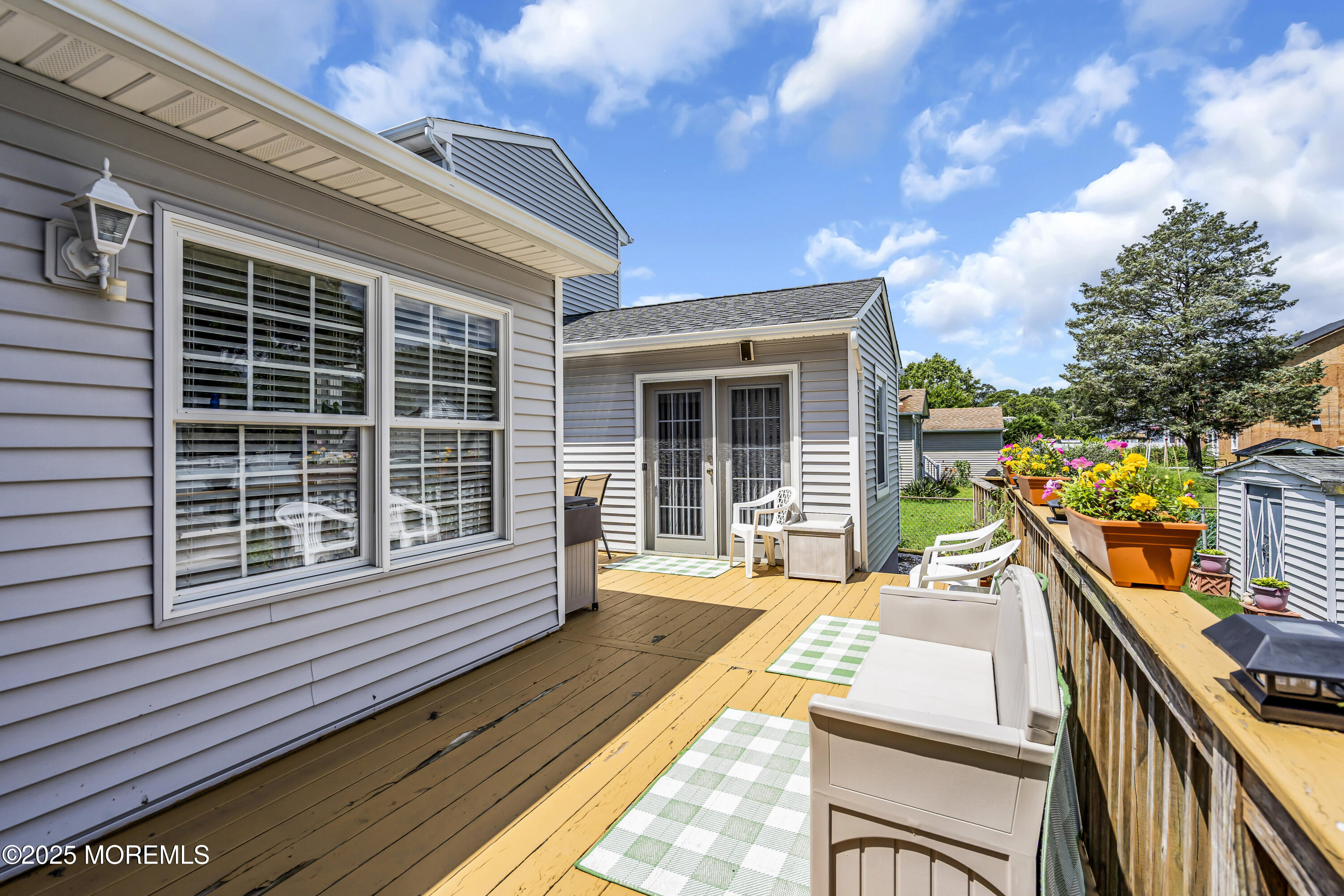 2221 Wilson Road Point Pleasant, NJ 08742 - Photo 46 of 63 a view of a house with a wooden deck