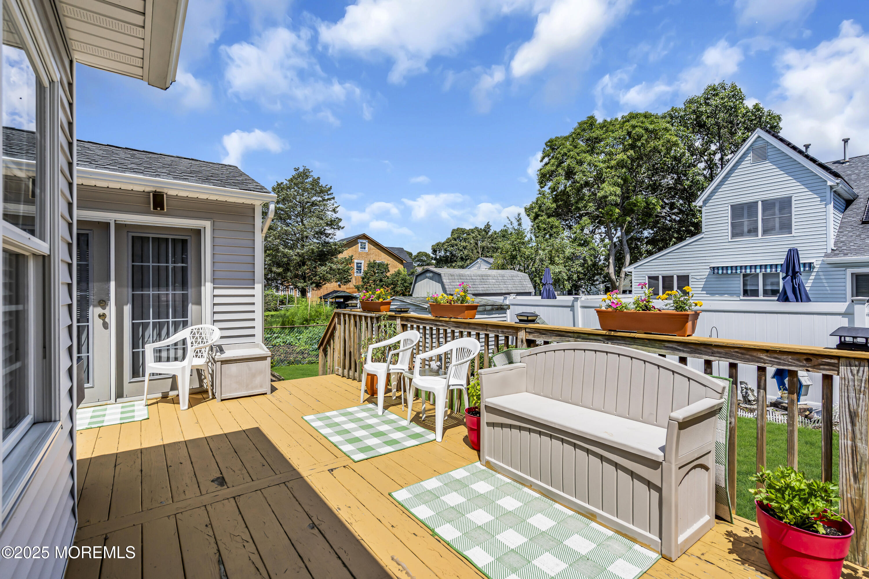 2221 Wilson Road Point Pleasant, NJ 08742 - Photo 47 of 63 a view of a house with wooden deck and furniture