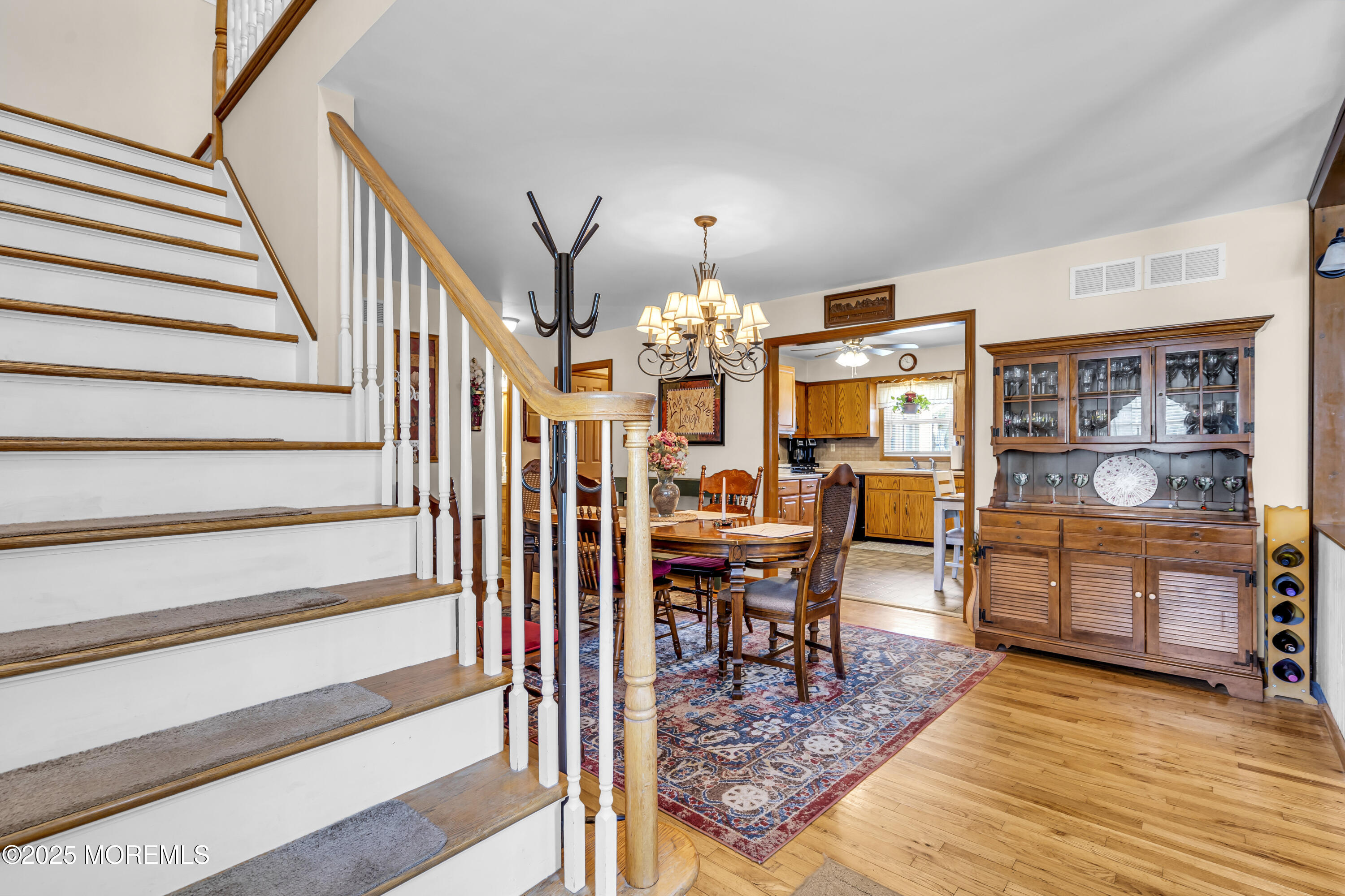 2221 Wilson Road Point Pleasant, NJ 08742 - Photo 6 of 63 a view of a dining room and hall with wooden floor