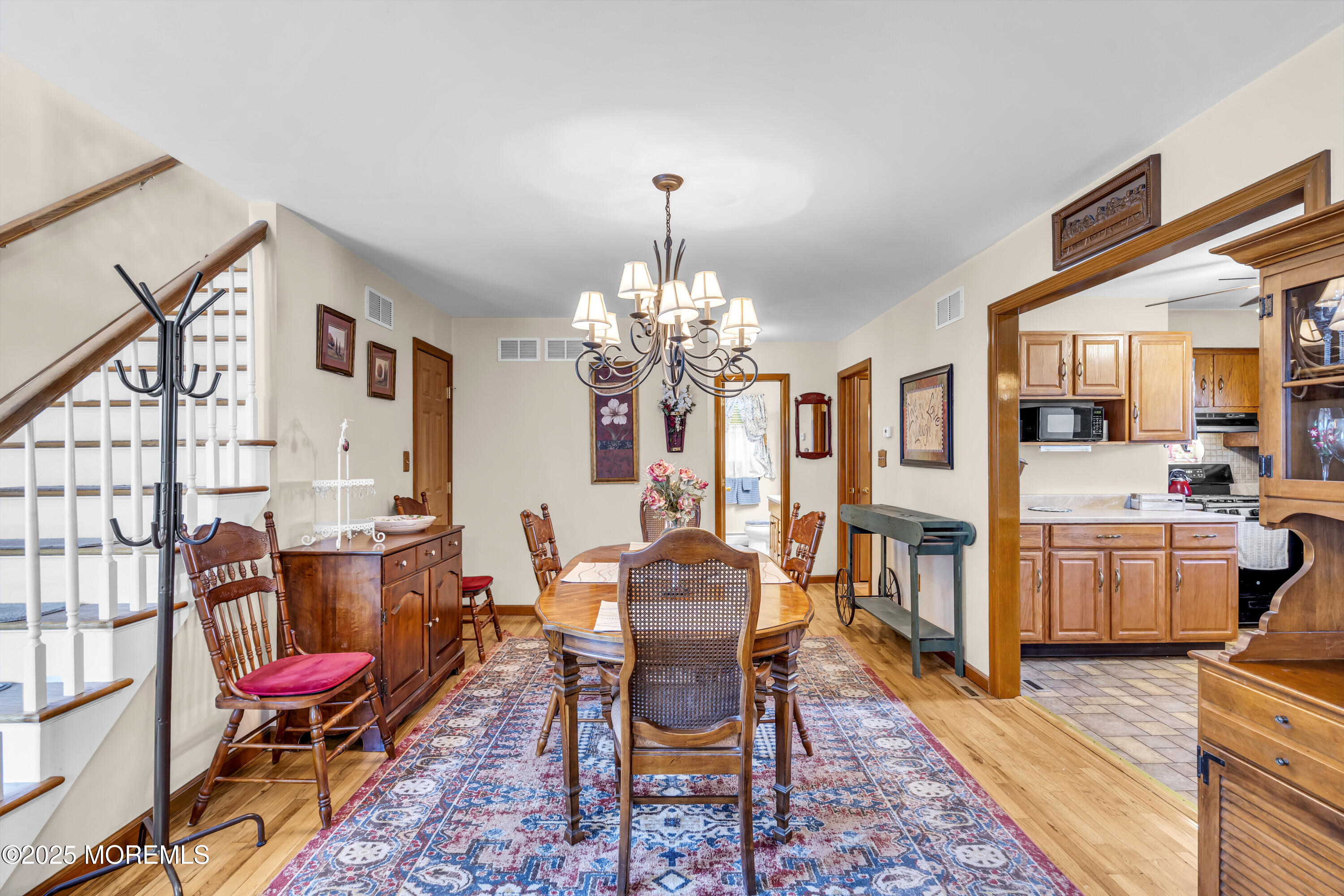 2221 Wilson Road Point Pleasant, NJ 08742 - Photo 8 of 63 a dining room with furniture a chandelier and wooden floor