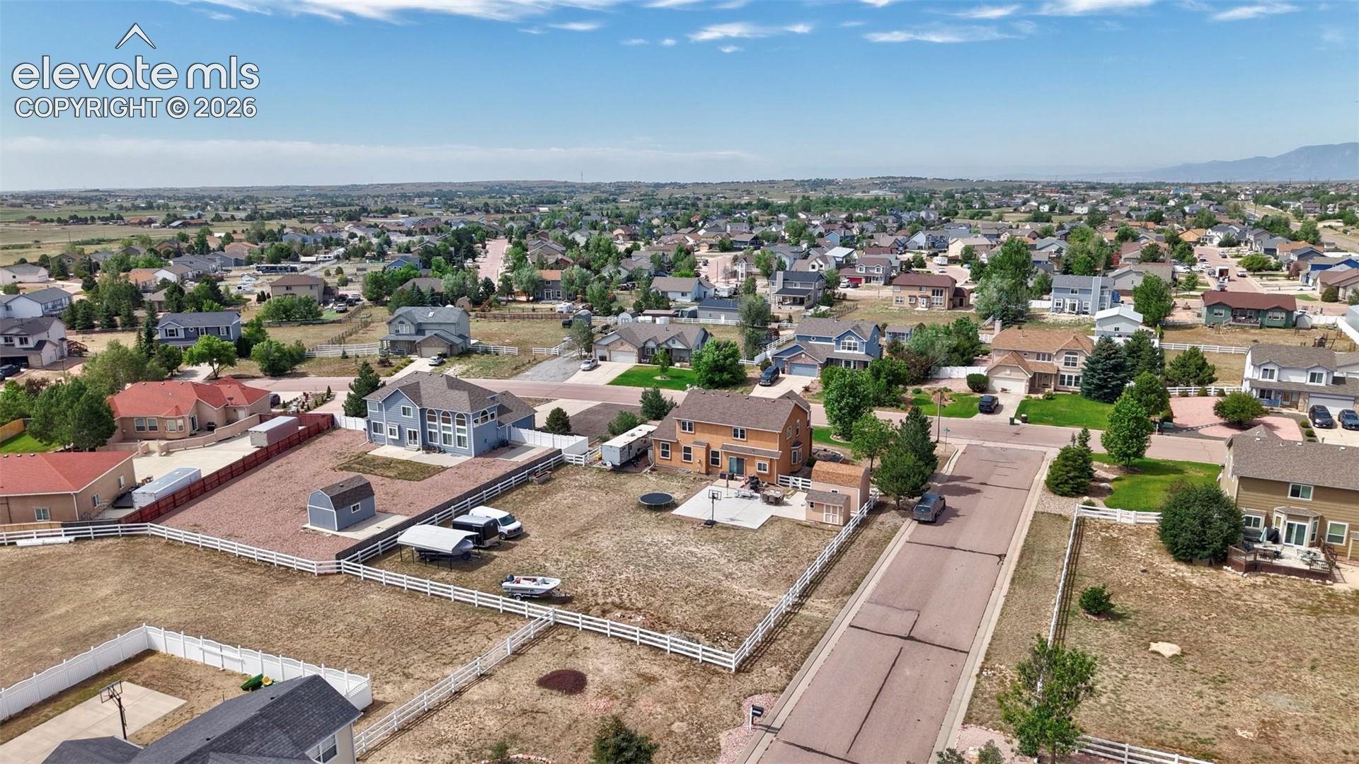 8347 Tibbs Road Peyton, CO 80831 - Photo 36 of 38 Expansive suburban landscape featuring a collection of detached homes, paved streets, and a clear blue sky