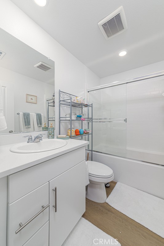 7395 Olive Grv Street Riverside, CA 92507 - Photo 12 of 18 Upstairs full bathroom with tub-shower combo and glass enclosure.