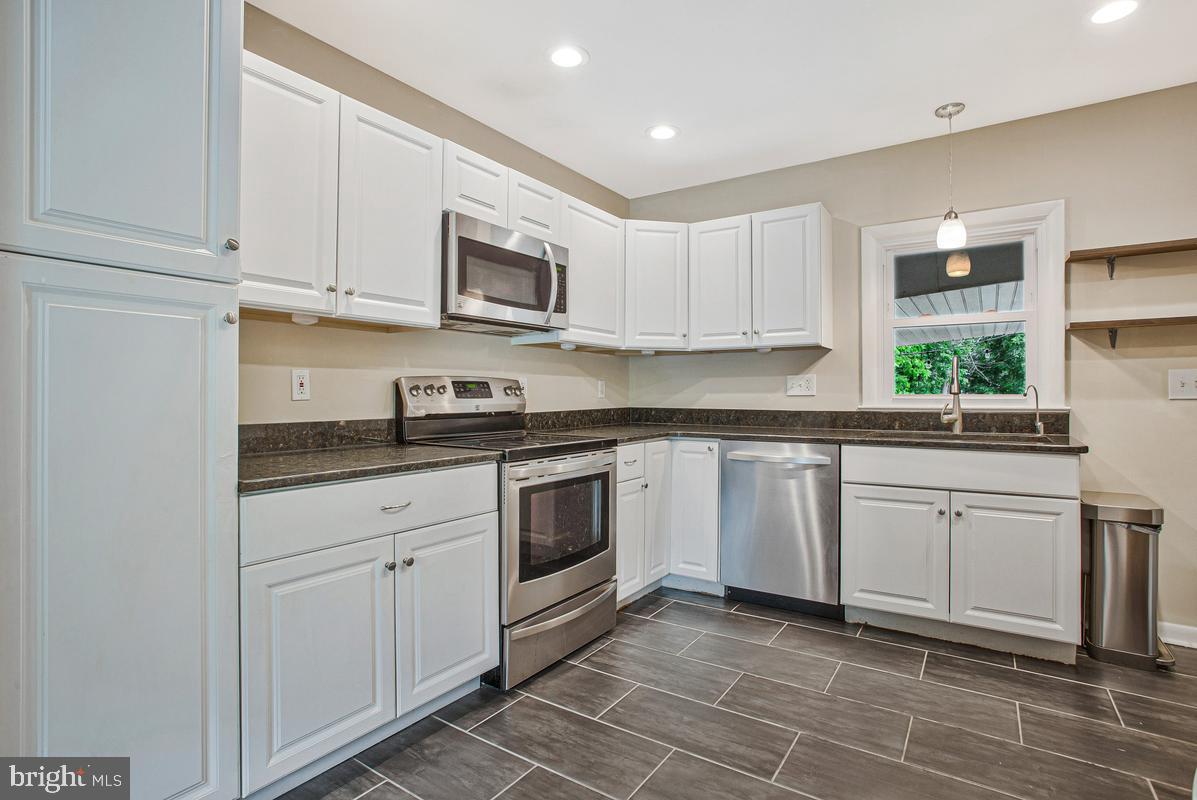 976 Shore Acres Road Arnold, MD 21012 - Photo 13 of 40 a kitchen with stainless steel appliances granite countertop a sink and a stove