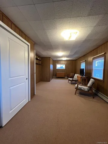 a view of a livingroom with furniture and a window