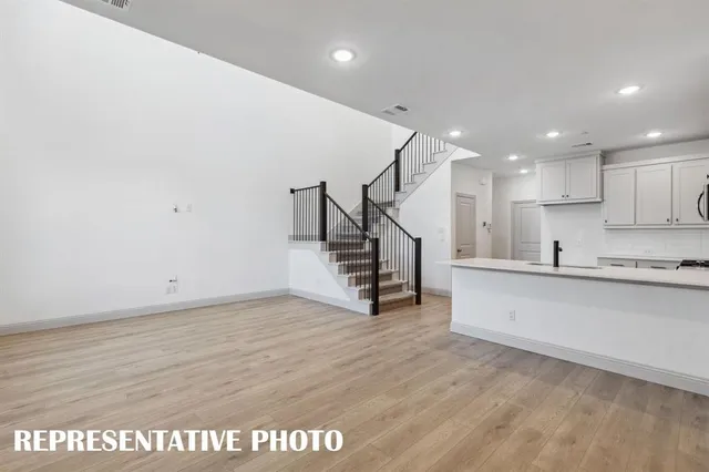 a view of kitchen with wooden floor and electronic appliances